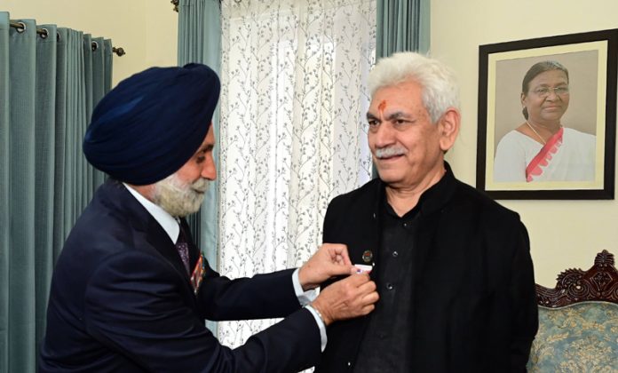 Armed Forces flag being pinned on LG Manoj Sinha at Raj Bhawan in Jammu on Saturday.