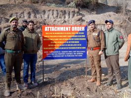 Police and district Rajouri administration officials seizing a terrorist's property in Kotranka on Friday.