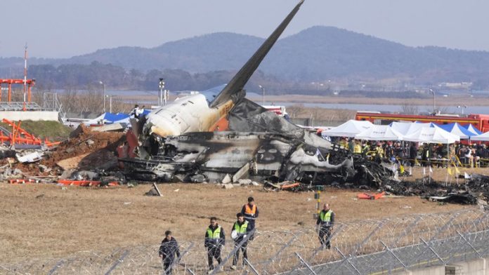 Firefighters and rescue teams work near the wreckage of a passenger plane at Muan International Airport in Muan, South Korea on Sunday.