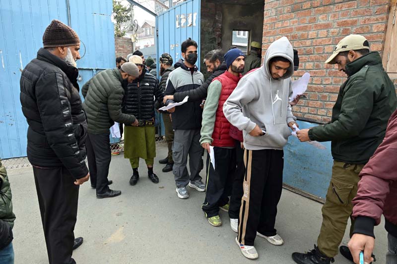 Candidates outside the examination center in Chanapora area of Srinagar on Sunday.