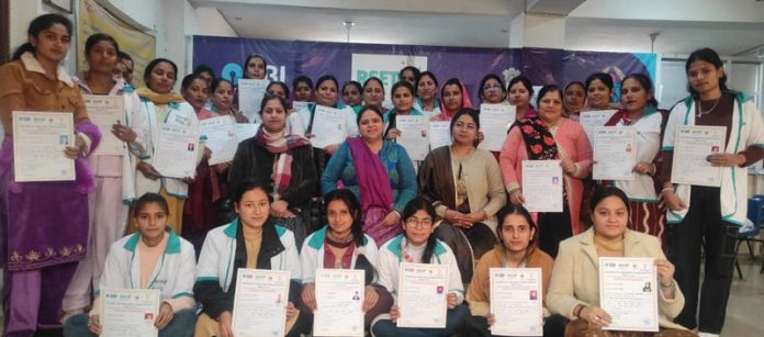 Candidates of training programme posing together with their certificates.