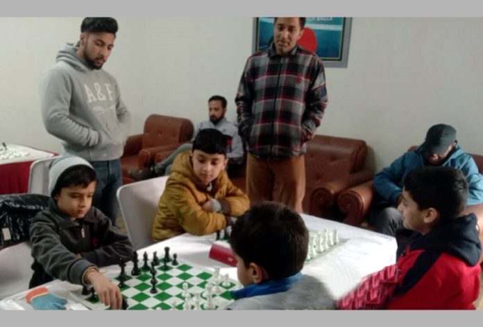 Chess players displaying keen interest during a game at Srinagar.