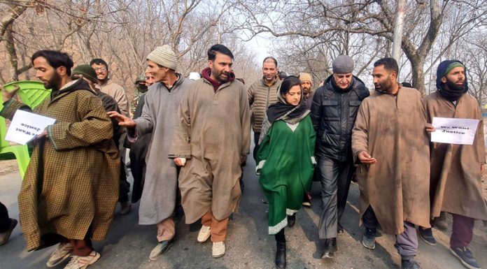 PDP protesting against passing of railway line through the agriculture and horticulture land of Liver Village in Anantnag. -Excelsior/Sajad Dar