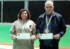 Romesh Sharma and Neera Pacricha posing along with medals and certificates.