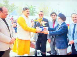 MP Jugal Kishore Sharma receiving plant during annual day event of IDPS Akhnoor.