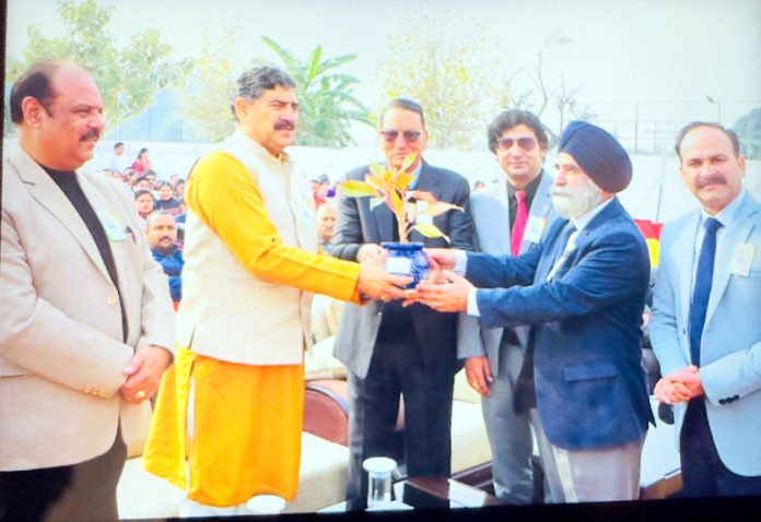 MP Jugal Kishore Sharma receiving plant during annual day event of IDPS Akhnoor.