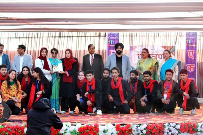 Students posing along with dignitaries during a programme.