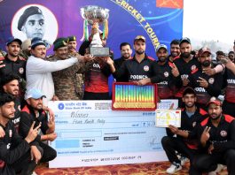 Winning team posing along with dignitaries and trophy during prize distribution ceremony at Nowshera. -Excelsior/Imran