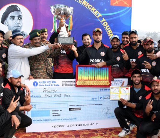 Winning team posing along with dignitaries and trophy during prize distribution ceremony at Nowshera. -Excelsior/Imran