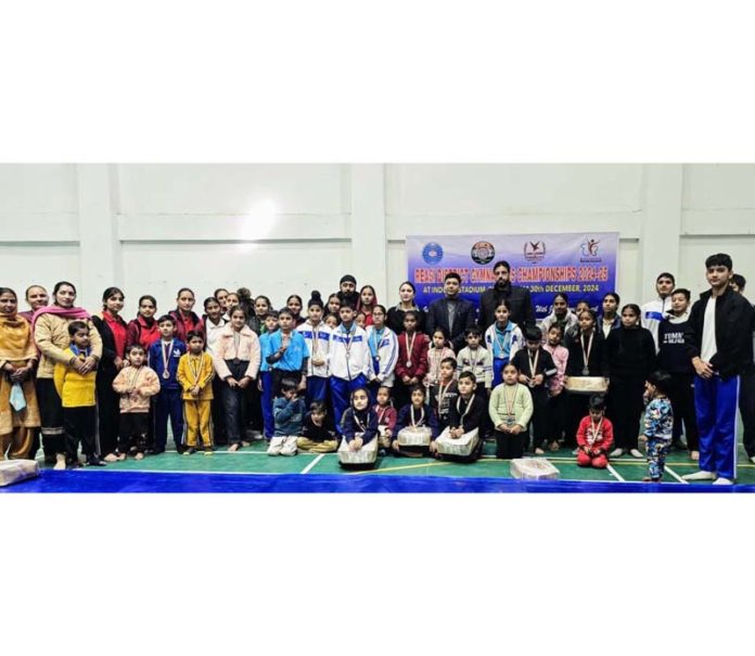 Gymnasts posing along with dignitaries during a championship at Reasi.