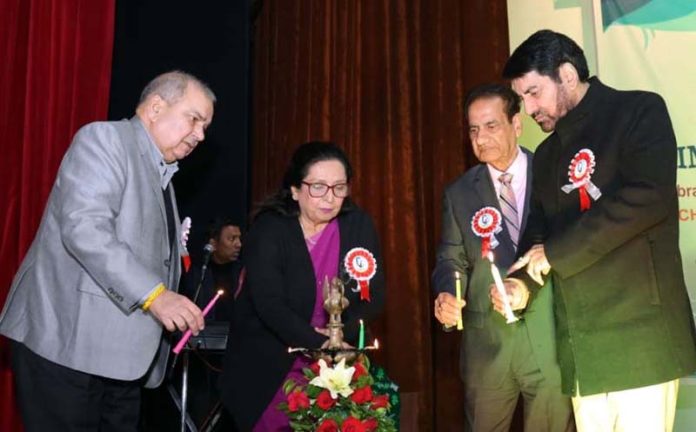 Dignitaries lighting traditional lamp during Annual Day event on Monday.