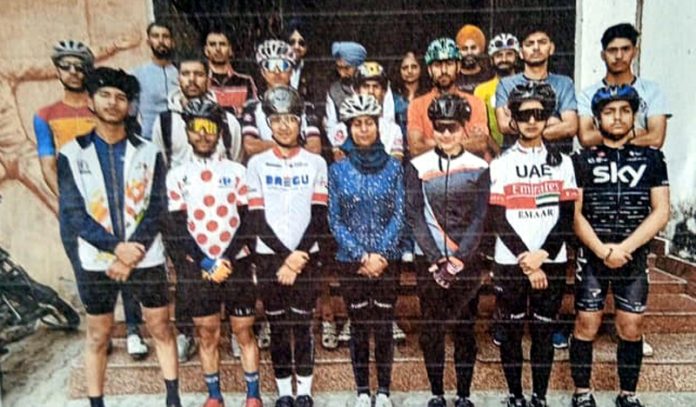 Selected cyclists posing for group photograph.