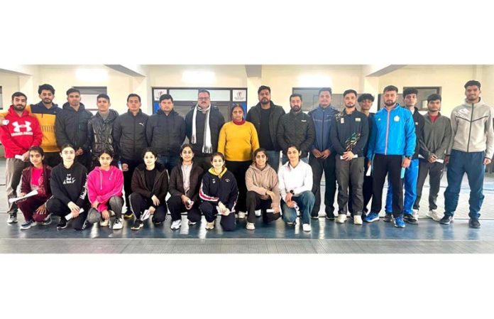 Selected boys and girls fencing teams posing along with dignitaries.