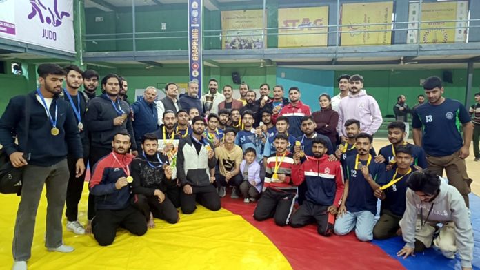 Grappling players posing along with medals during prize distributing ceremony at Jammu University.