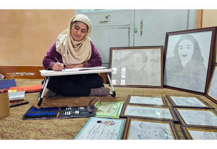 Zia Zahoor engrossed in sketch making at her residence at Hawal. -Excelsior/Shakeel