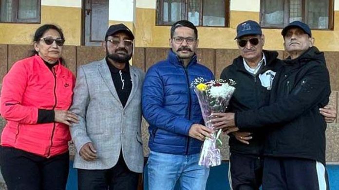 J&K UT Masters Athletics Association members presenting bouquet to chief guest.