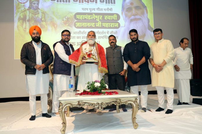 Members of GIEO Gita felicitating Gita Manishi Swami Gyananand during a function held in Jammu on Tuesday.