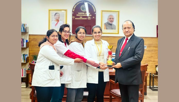 AIIMS Jammu's chess team posing with Prof. Dr. Shakti Kumar Gupta, Executive Director & CEO of AIIMS Jammu, holding their trophy.