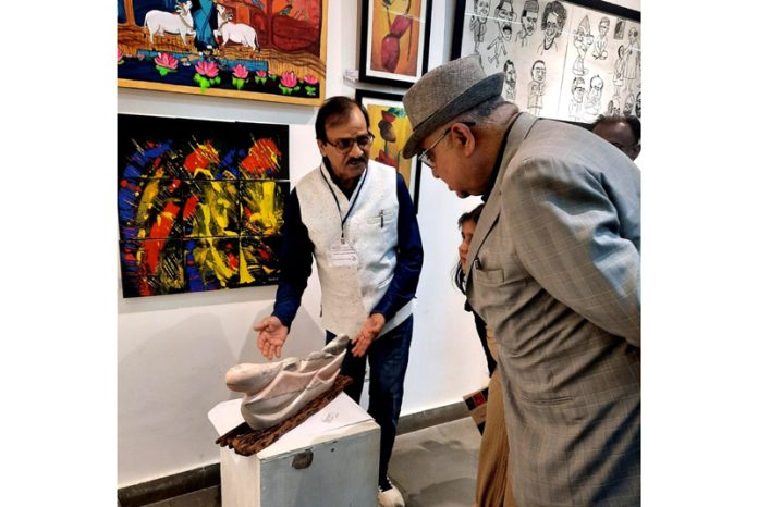 Acclaimed Sculptor Ganesh Kumar Sharma explaining his art work to a dignitary at Exhibition 'Beyond Limits 2024' in New Delhi.