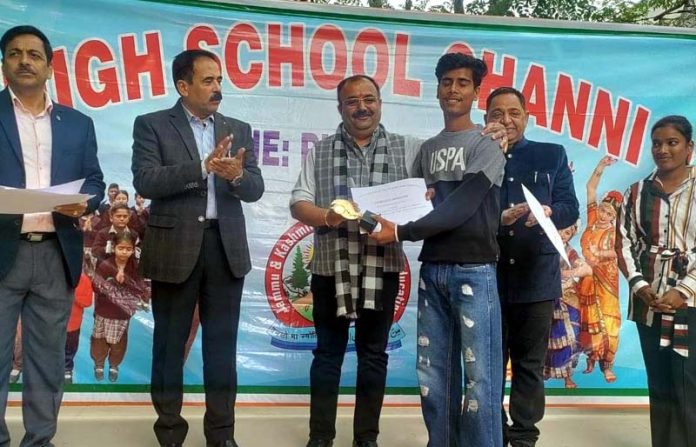 MLA Bahu Constituency, Vikram Randhawa presenting certificates to a student during the Annual Day event.