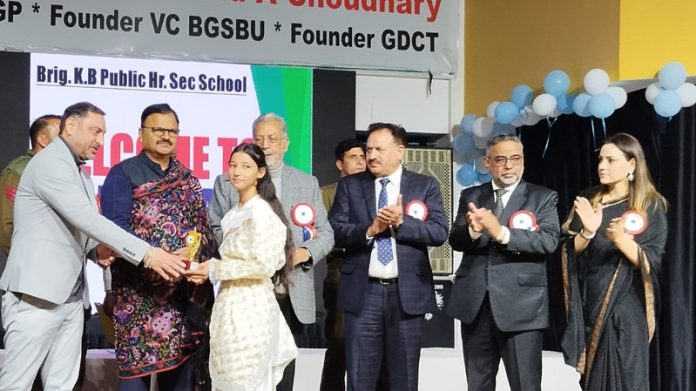 Minister Javed Ahmad Rana presenting trophy to a student during Annual Day event at Jammu.