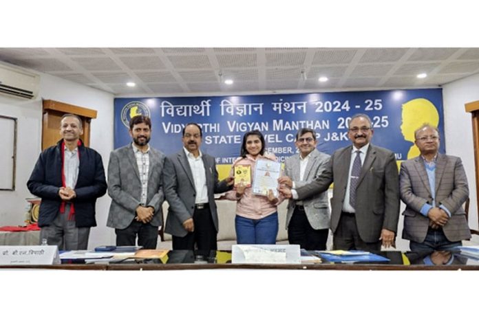 Dignitaries presenting award to a student during a programme at Jammu.