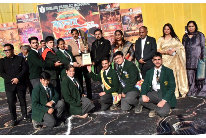 YS&S Minister Satish Sharma, MLA Udhampur-West, Pawan Kumar Gupta and students posing along with trophy during Annual Day event at DPS Udhampur.