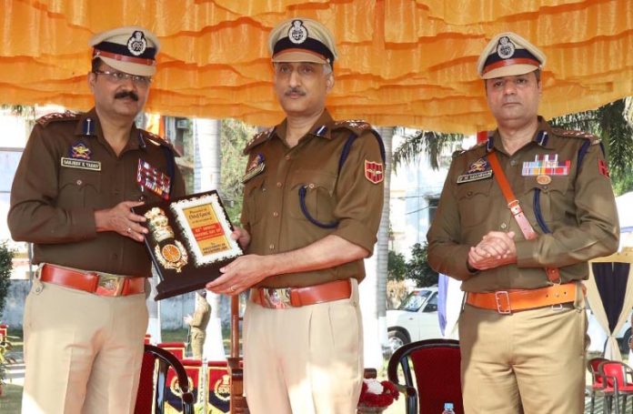 A senior SDRF officer presenting a memento to another officer in Jammu on Friday.