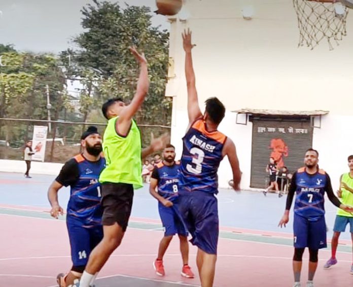 Players in action during ongoing J&K Senior Basketball Championship at MA Stadium.