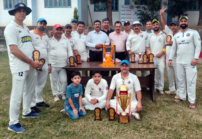 Winning team posing along with trophies.