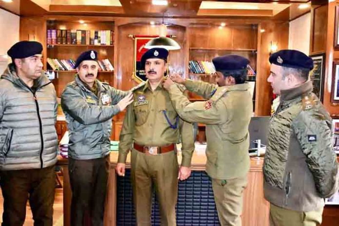 DIG Javid Iqbal Matoo and SSP Dr G V S Chakravarthy pinning new rank to newly promoted DySP at RPHQ Anantnag on Saturday. -Excelsior/Sajad Dar