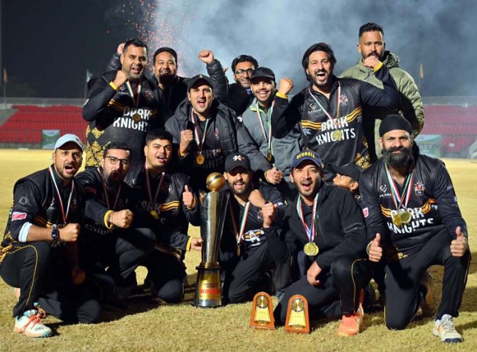 Winning team posing along with a trophy at MA Stadium, Jammu.