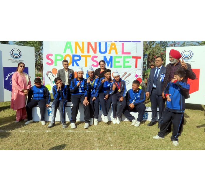 Students posing along with medals during Sports Day event on Friday.