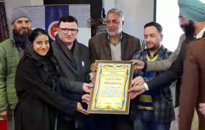 A JKAS exam qualifier girl from Poonch being felicitated by Aasra Charitable Trust Chairman, Rayaz Tantray and other members of Trust.