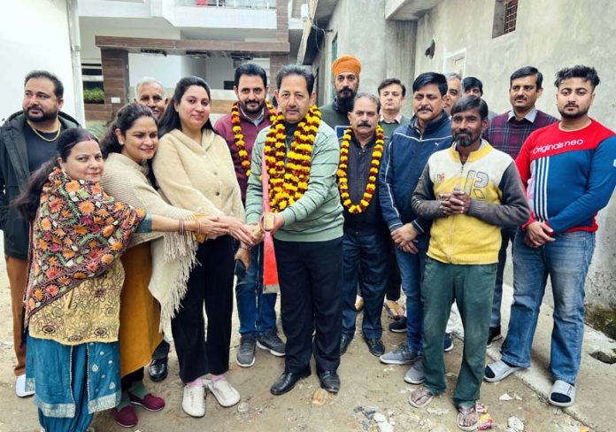 Former Dy Mayor, Baldev Singh Billawaria kick starting laying of tiles in lanes at Gangyal.