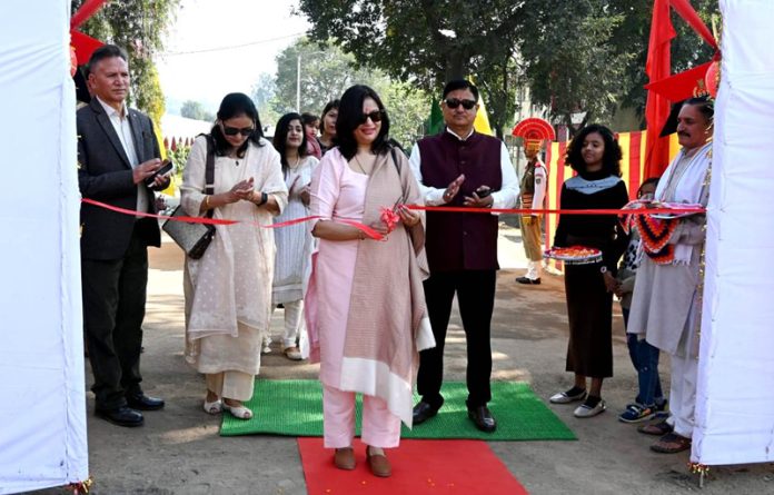 A dignitary cutting the traditional ribbon to celebrate the BSF Raising Day in Udhampur on Sunday.