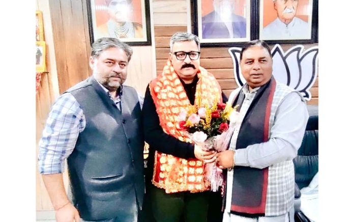 BJP president, Sat Sharma honouring party leader, Zorawar Singh Jamwal at Jammu on Saturday.