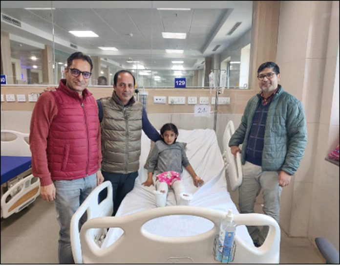 A team of doctors posing with a young patient on whom they performed a groundbreaking surgery at AIIMS Jammu.