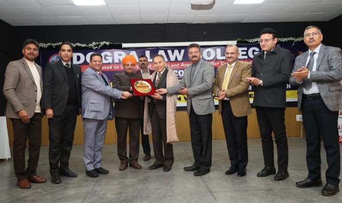 Th Gulchain Singh Charak honouring Chief Justice Tashi Rabstan during interactive session at Dogra Law College.