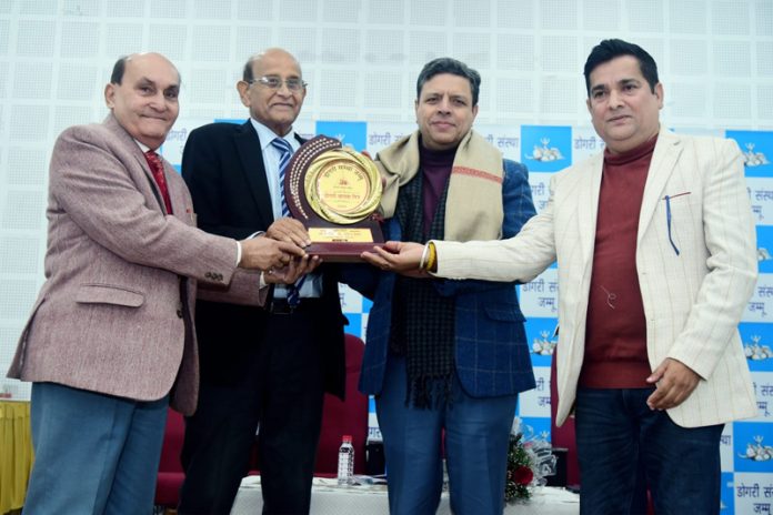 Dogri Sanstha honouring Sanjeev Verma, Commissioner Secretary GAD, during Dogri Maanta Din celebration at Jammu on Thursday.