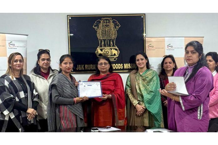 MD JKRLM, Shubhra Sharma presenting certificate to a participant of financial literacy program.