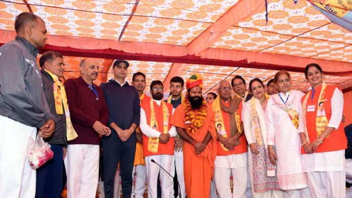 Swami Dr. Parmarth Dev along with others during a Yoga convention in Chomu, Rajasthan on Monday.