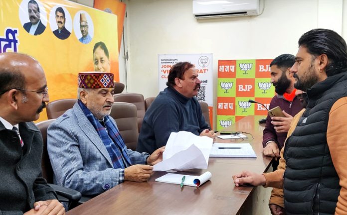 BJP MLAs, Sham Lal Sharma and Mohan Lal Bhagat holding a public darbar at party office, Jammu on Monday.