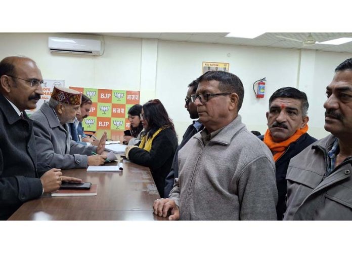 BJP leaders, Sham Lal Sharma and Mohan Lal Bhagat listening public grievances at Jammu on Monday.