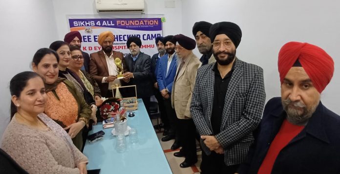 Congress leader Taranjit Singh Tony posing along with members of NGO in Jammu on Tuesday.