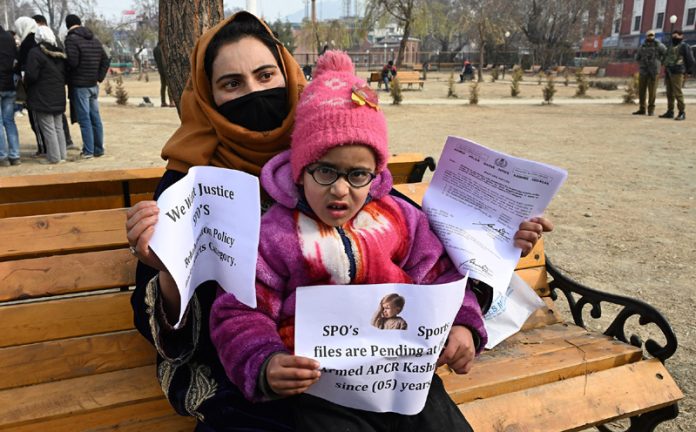 Family members of SPO during a silent protest in Srinagar on Saturday. -Excelsior/Shakeel