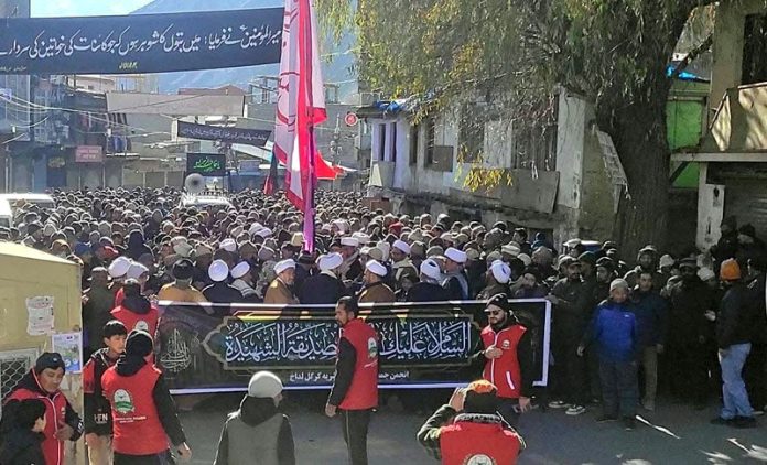 Mourners taking out a procession on martyrdom anniversary of Hazrat Fatima (SA) in Kargil. -Excelsior/Basharat Ladakhi