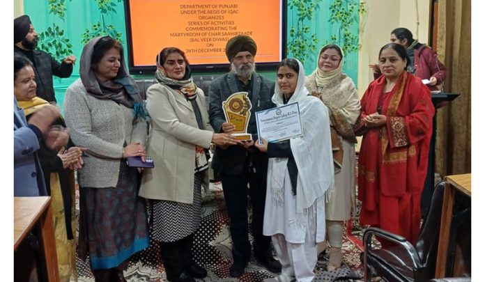 Chief guest, Dr Arvinder Singh Aman felicitating winner of quiz competition in Jammu on Saturday.