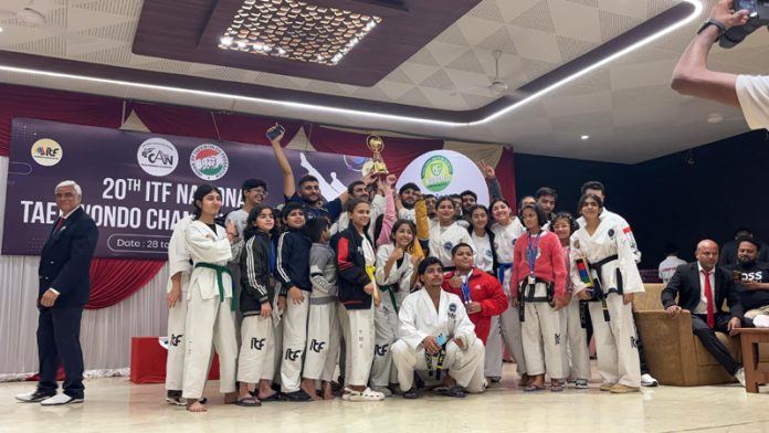 Taekwondo players of Jammu and Kashmir posing along with 1st runner-up trophy.