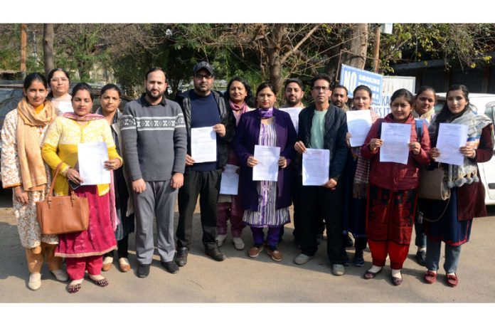 Scholars of Dogri and Kashmiri languages displaying copies of memorandum submitted to higher authorities. -Excelsior/Rakesh